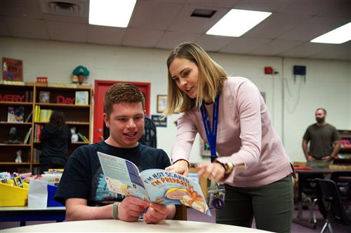 Teacher reading to student 