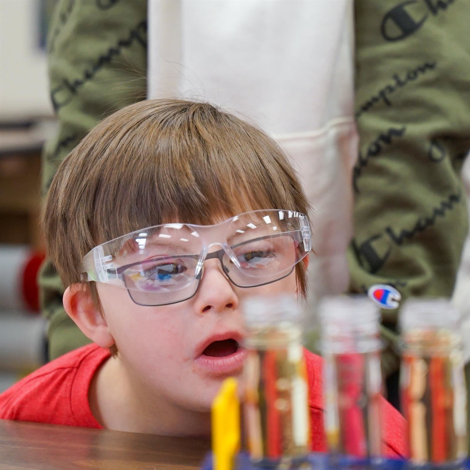 A student observing test tues during a science experiment at Mon Valley School