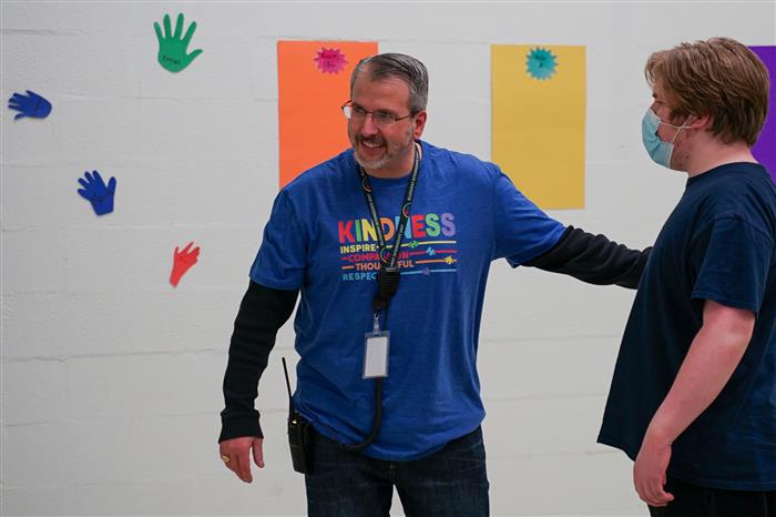 Mr. Nick thanks a student for helping him in the hand competition, as part of Pathfinder's Autism Awareness Month Celebration!