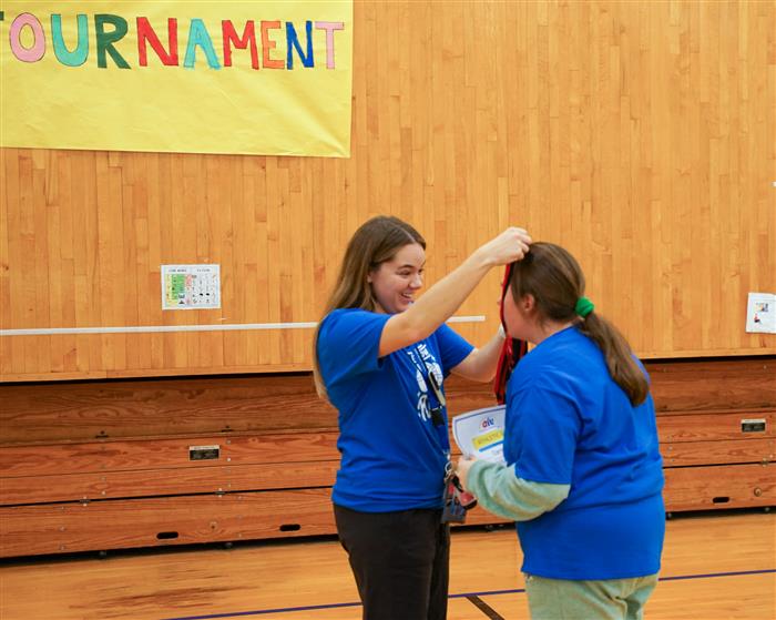 Student receives medal during the 2022 AIU Bocce Tournament