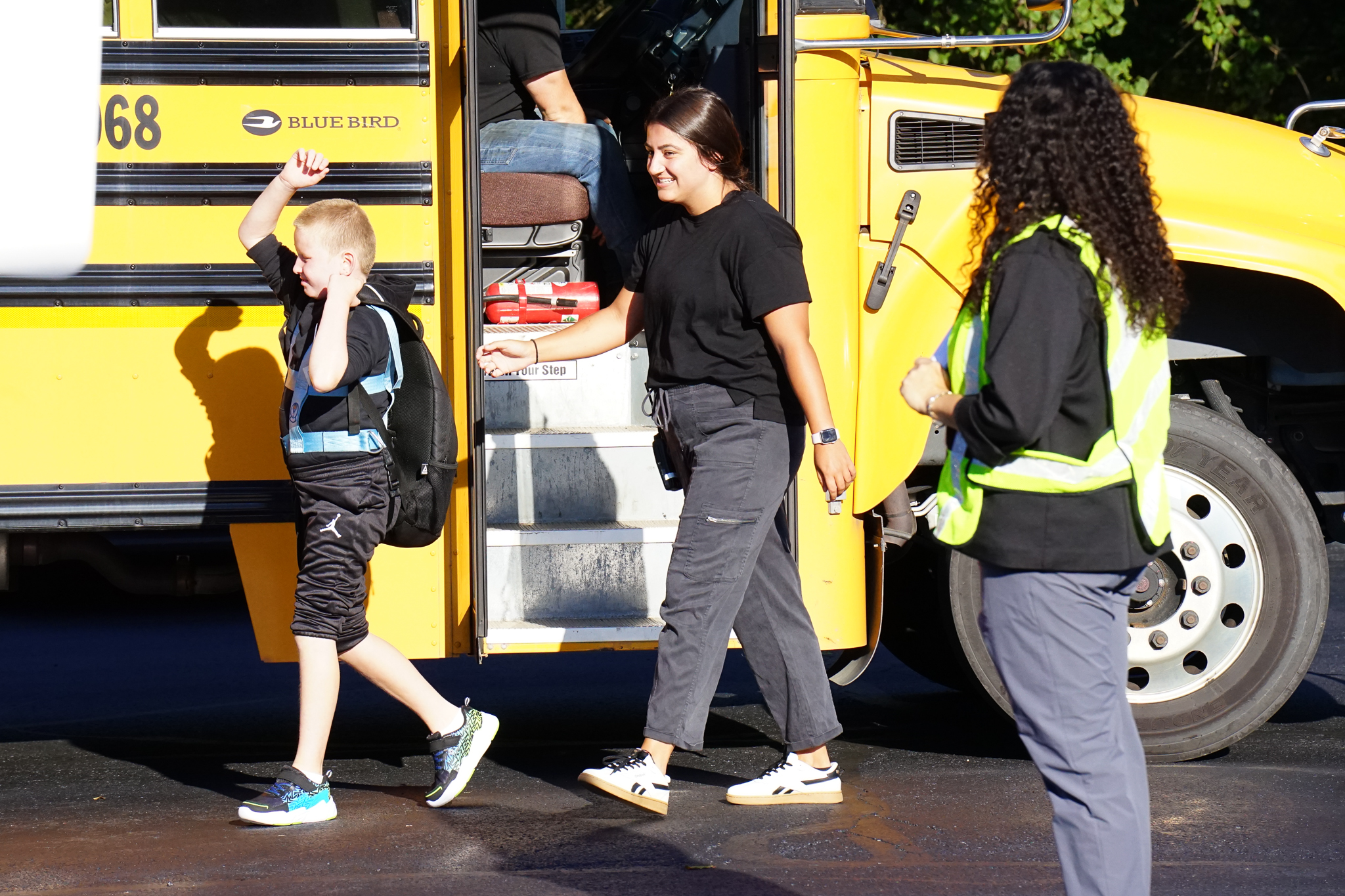 child stepping off the bus on the first day of school