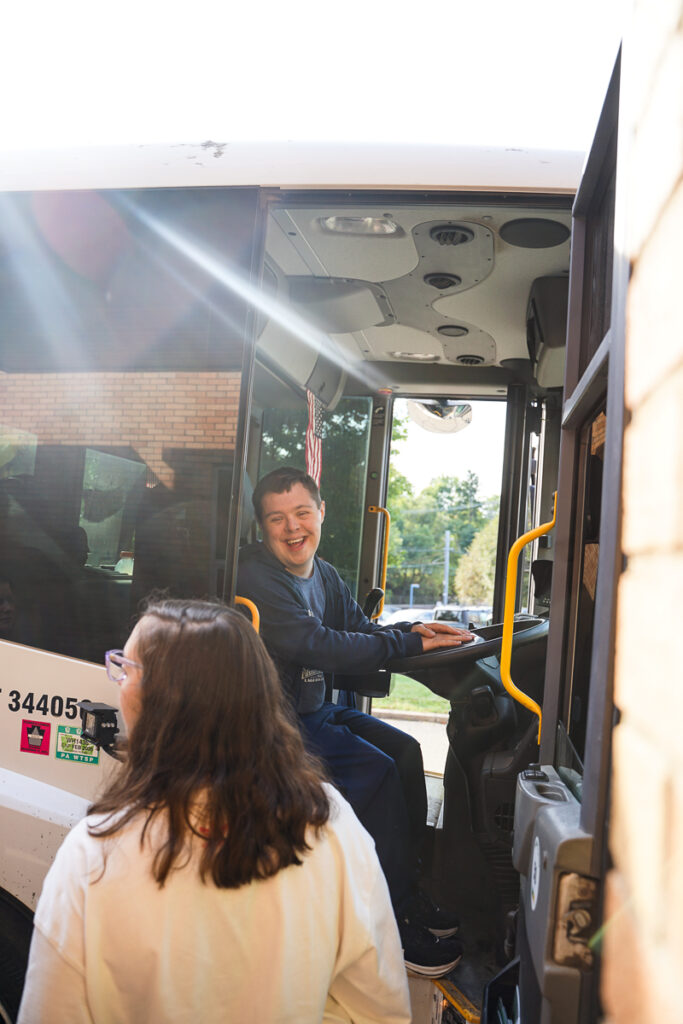 student sitting inside garbage truck