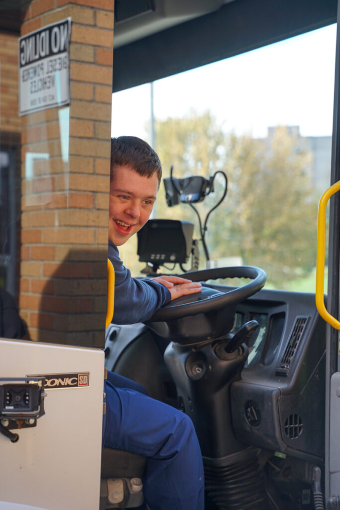 student sitting inside garbage truck