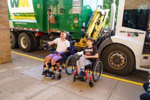 students outside garbage truck