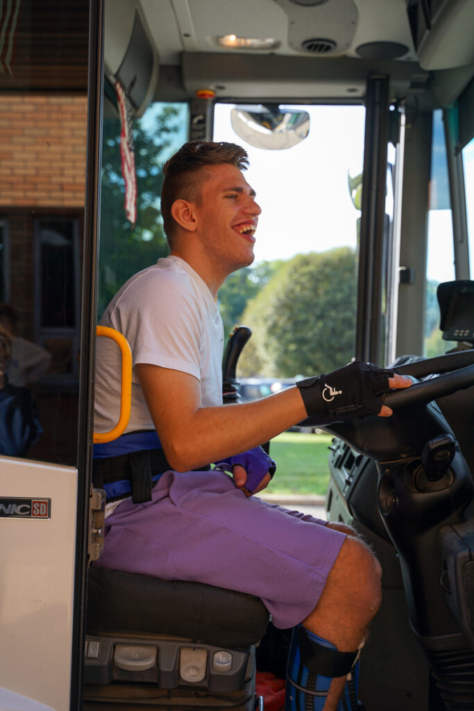 student sitting inside garbage truck