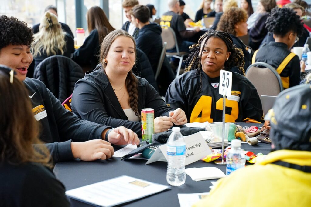 students talking at round tables
