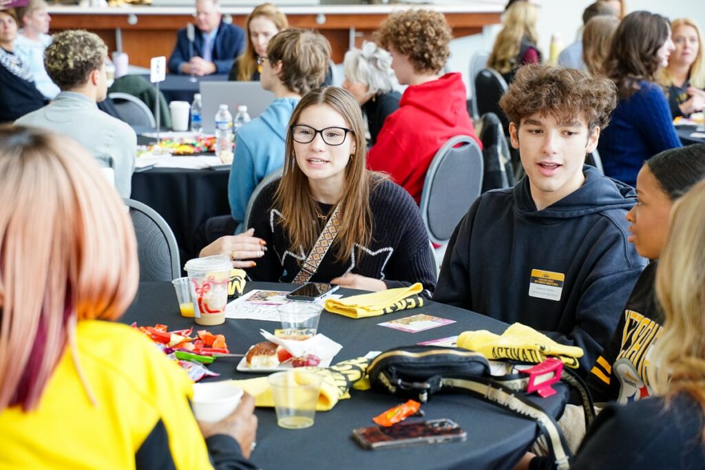 students talking at round tables