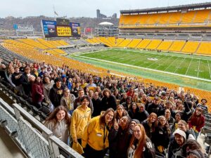 students posing inside football stadium