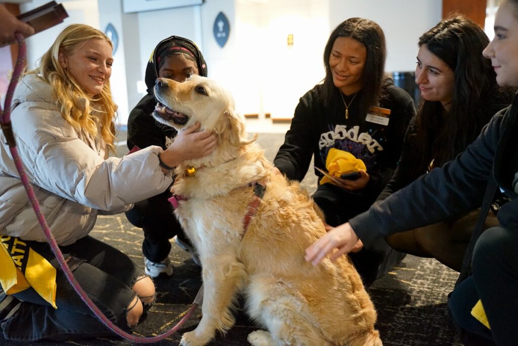 students petting therapy dog