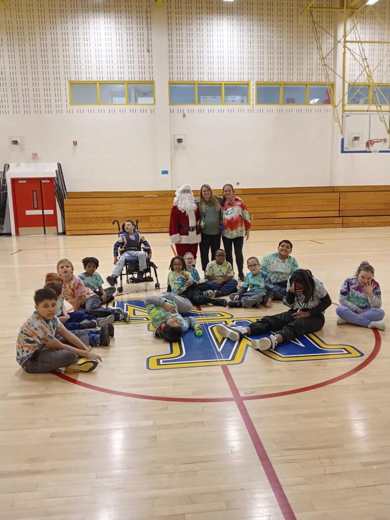 Santa kickball game with students