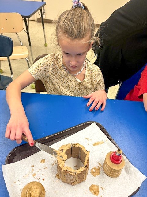 students building gingerbread house