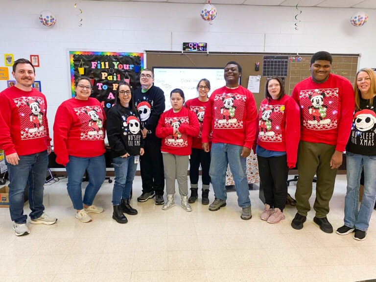 students celebrate christmas in matching sweaters