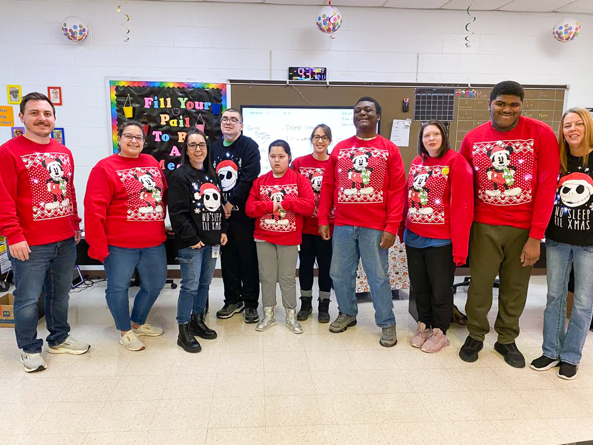students celebrate christmas in matching sweaters