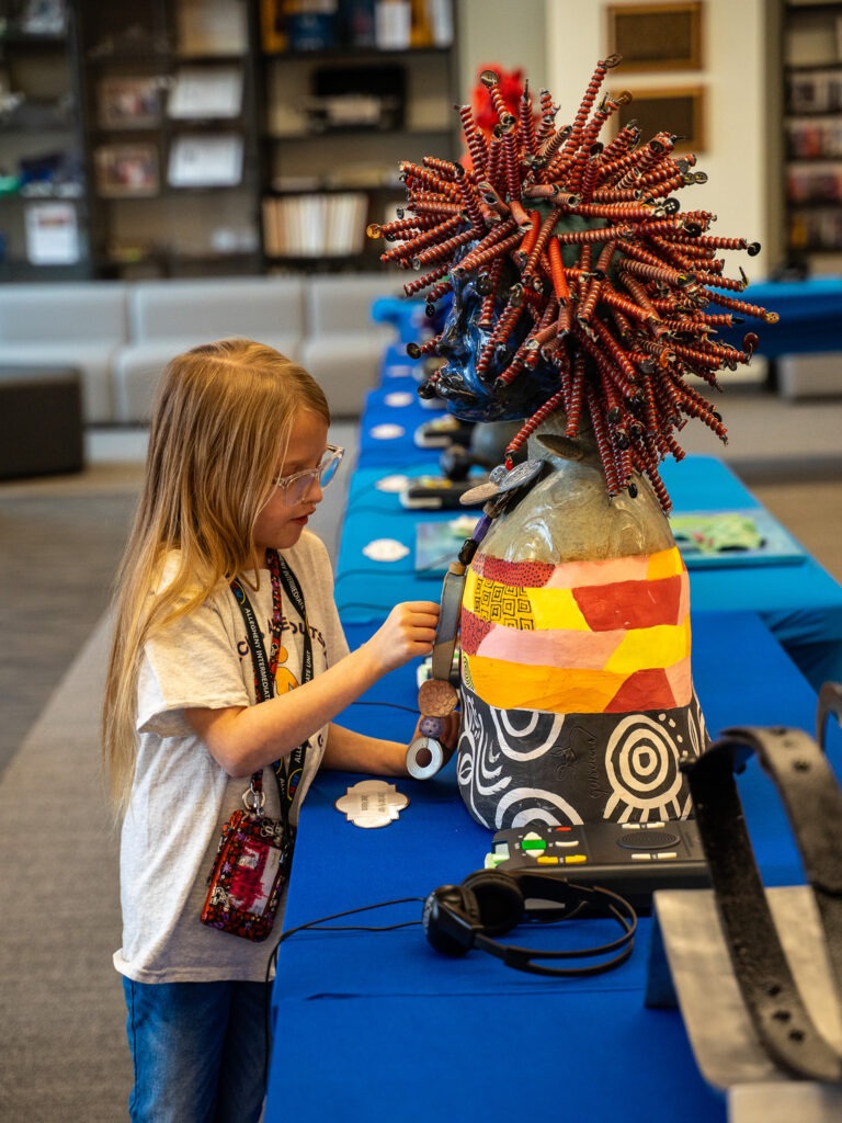 student interacts with tactile display at library for accessible media