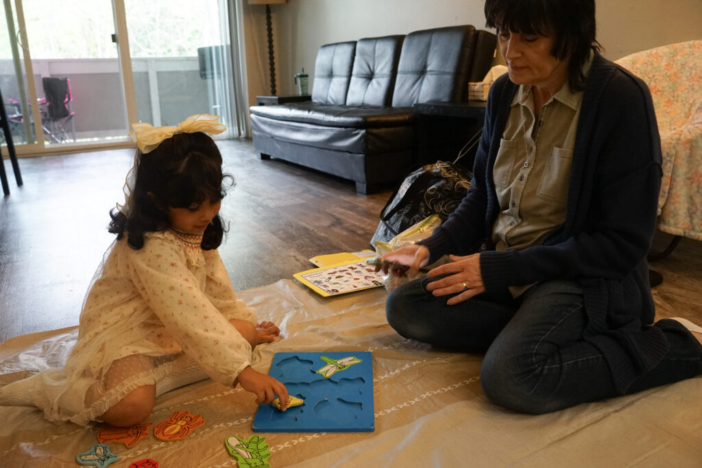 Michele and a head start student working on a puzzle