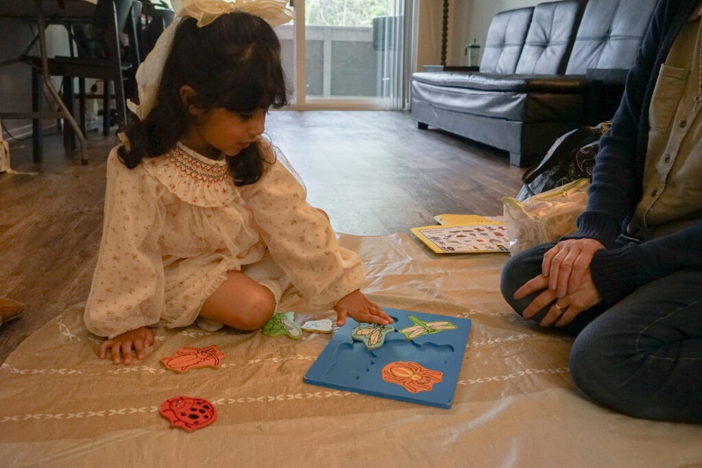Michele and a head start student working on a puzzle