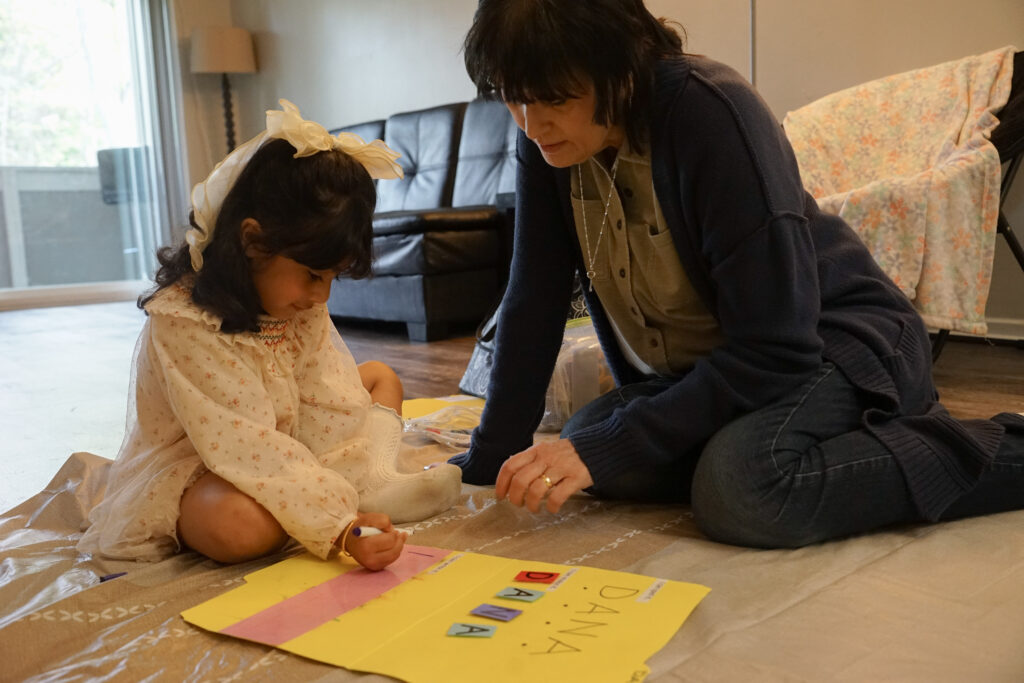 Michele helping a head start student spell her name