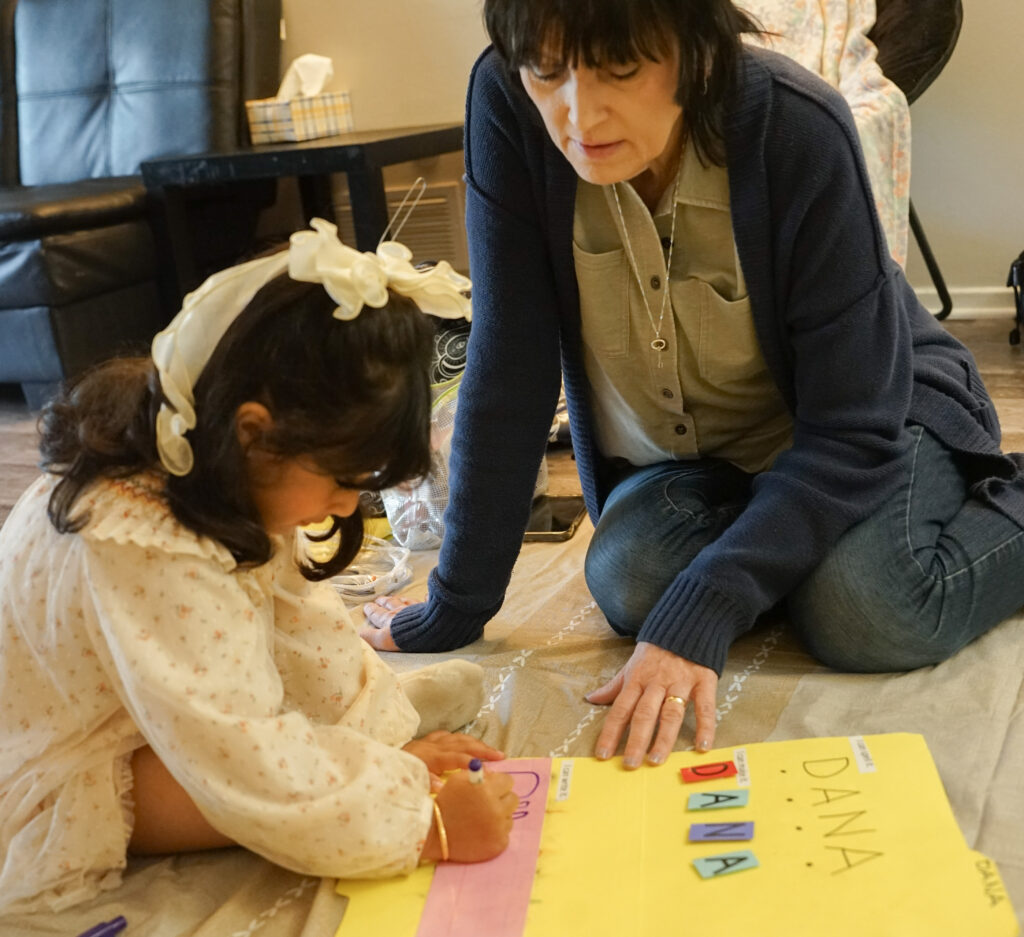 Michele helping a head start student spell her name