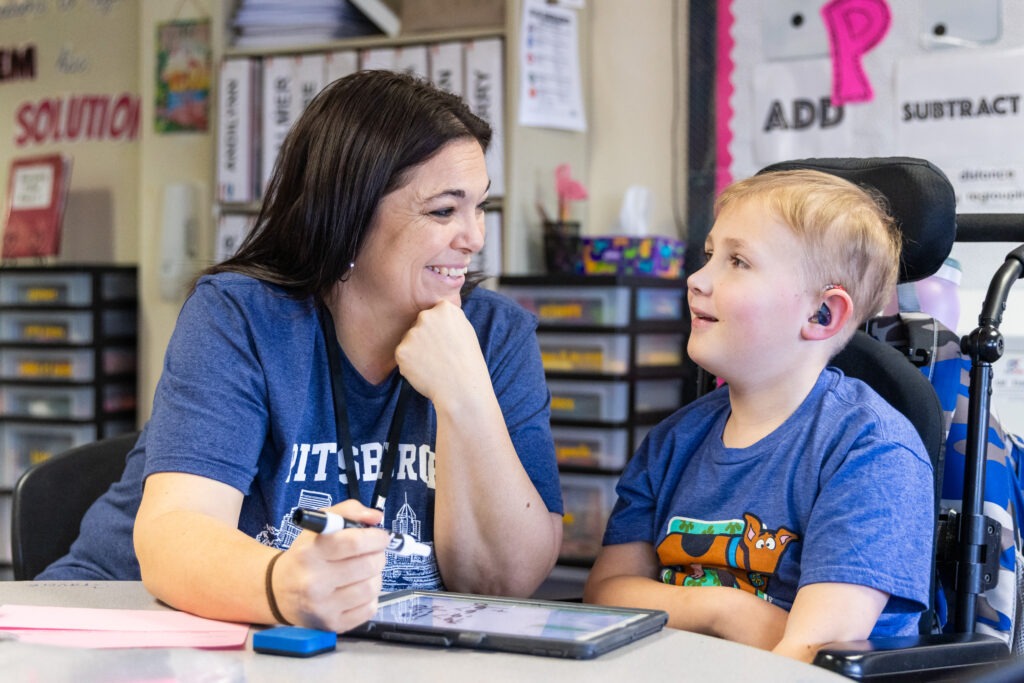 teacher and student work together on an assignment