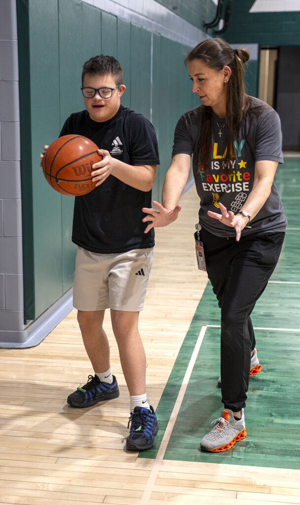 student play basketball with physical therapist