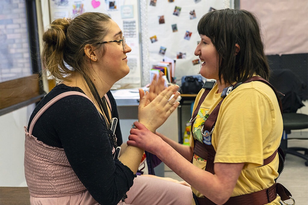 teacher and student interact in classroom