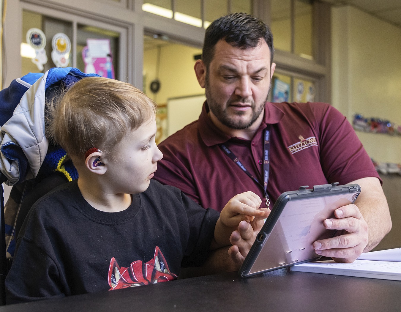 teacher of the visually impaired works with student