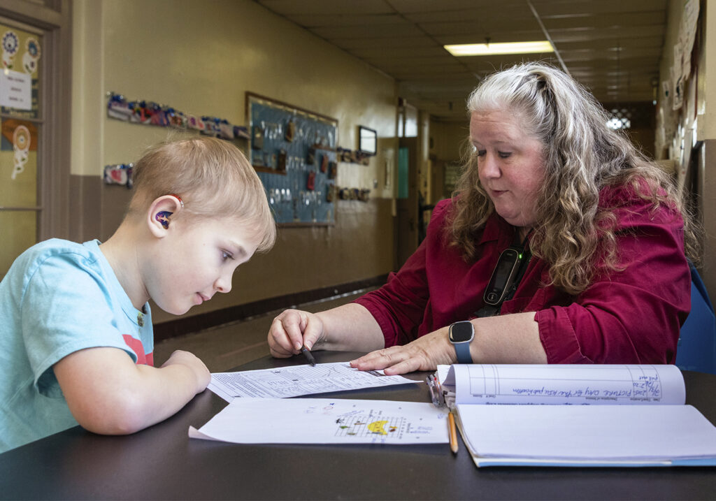 teacher of the deaf works with student