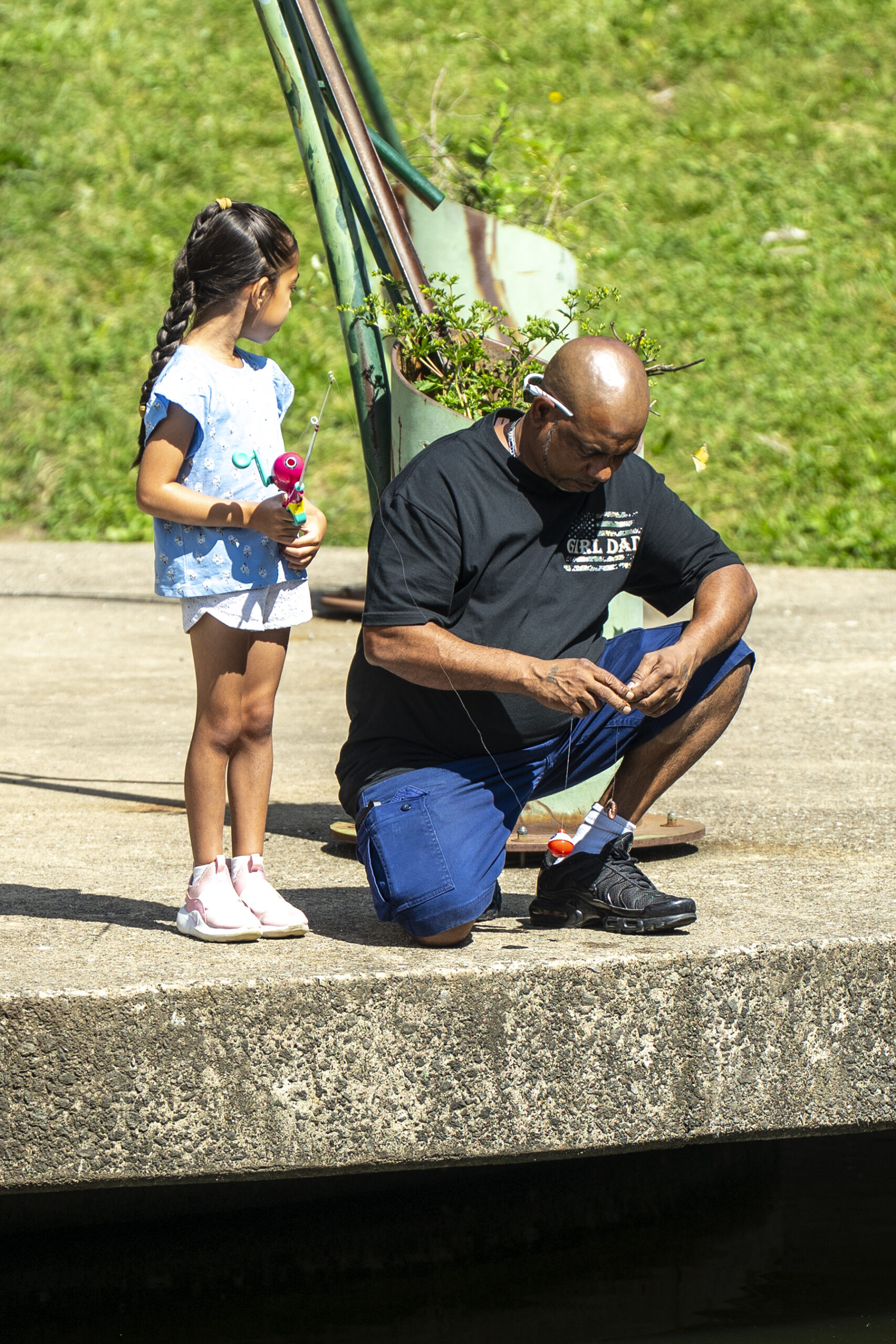 Dad helping daughter untangle fishing line