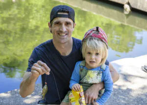 Father and daughter holding up a caught fish