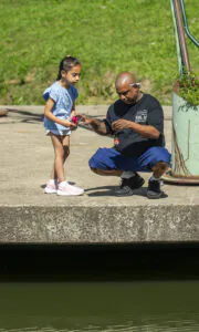 Dad helping daughter untangle fishing line