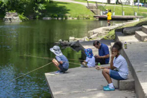 Families fishing in the shade by the lake