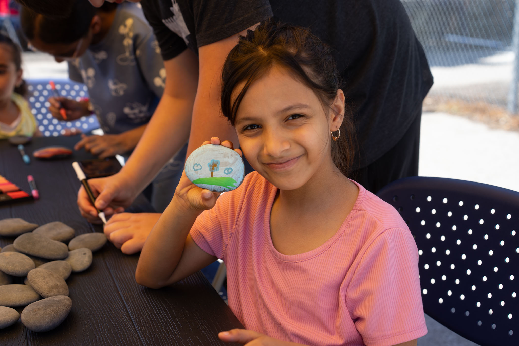 girl showing her painted rock