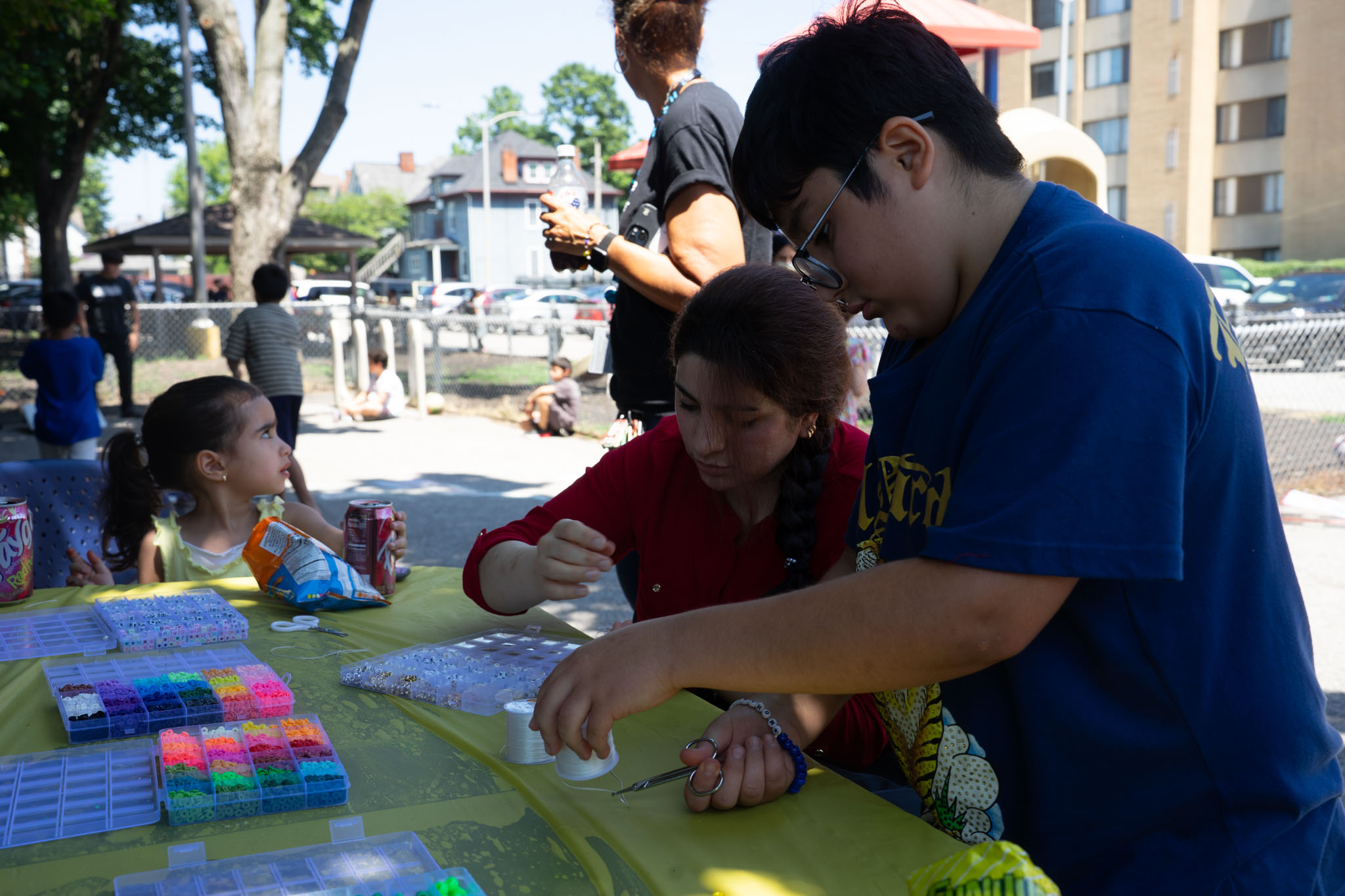 Families making friendship bracelets