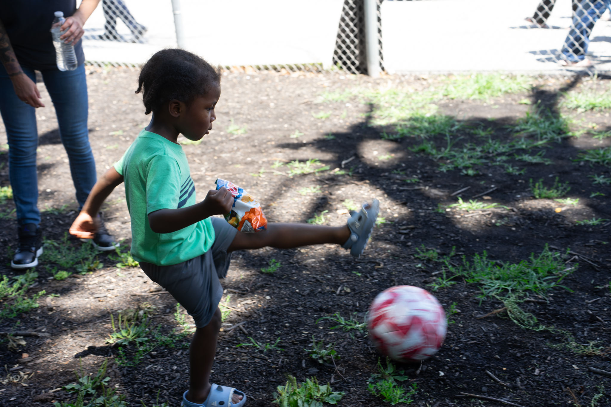 boy playing soccer with friends