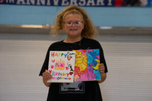 student sharing her art for the talent show