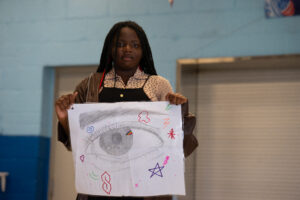 student sharing her art for the talent show