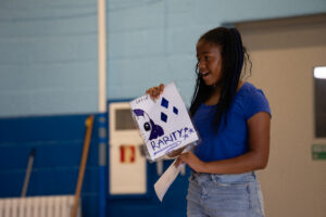 student sharing her art for the talent show