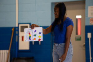 student sharing her art for the talent show