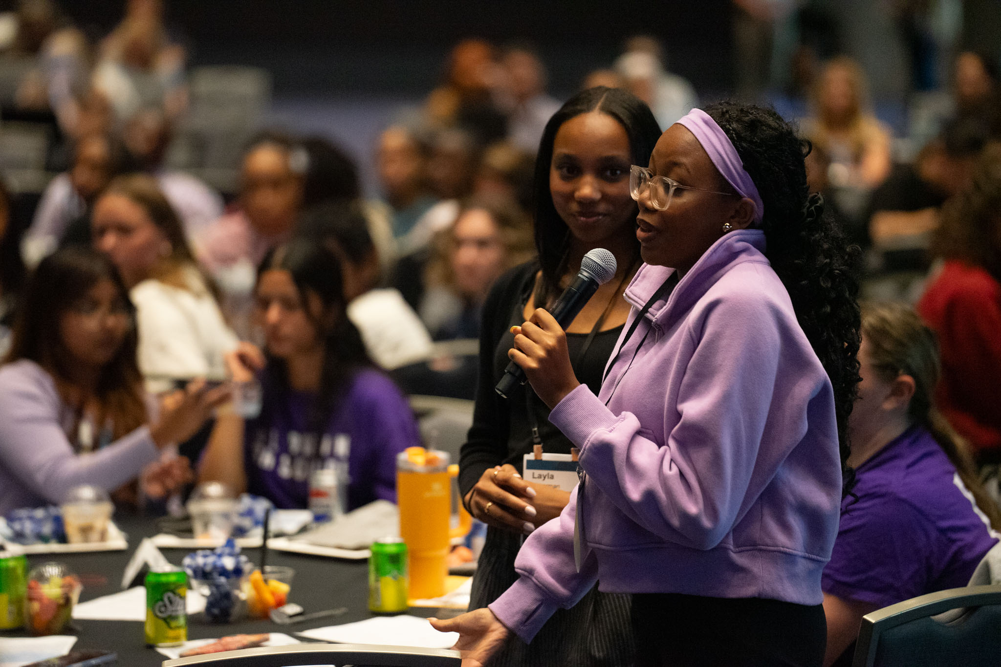 Audience member shares their experience with hate in front of the crowd