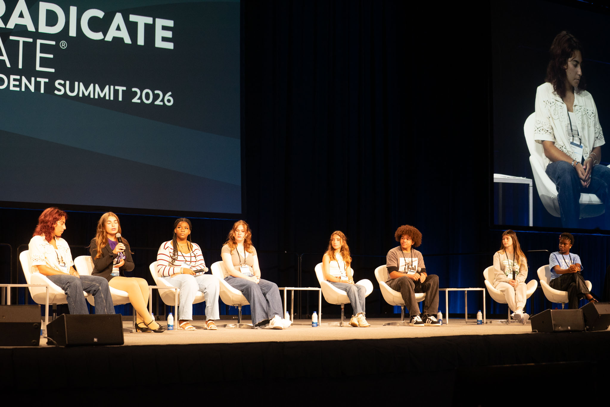 Student panelists on stage speaking to audience