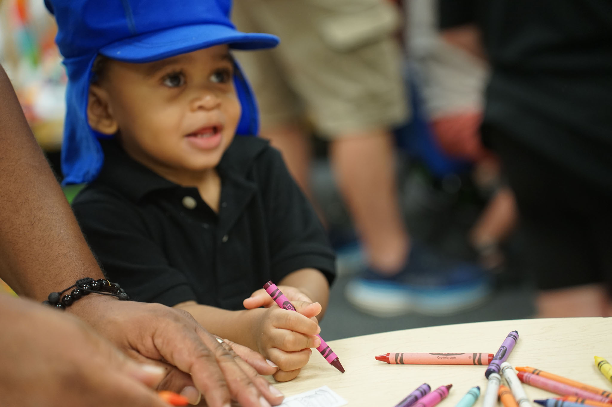 Child coloring with crayons