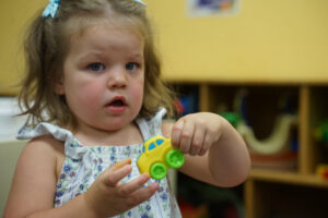 Child playing with toy car