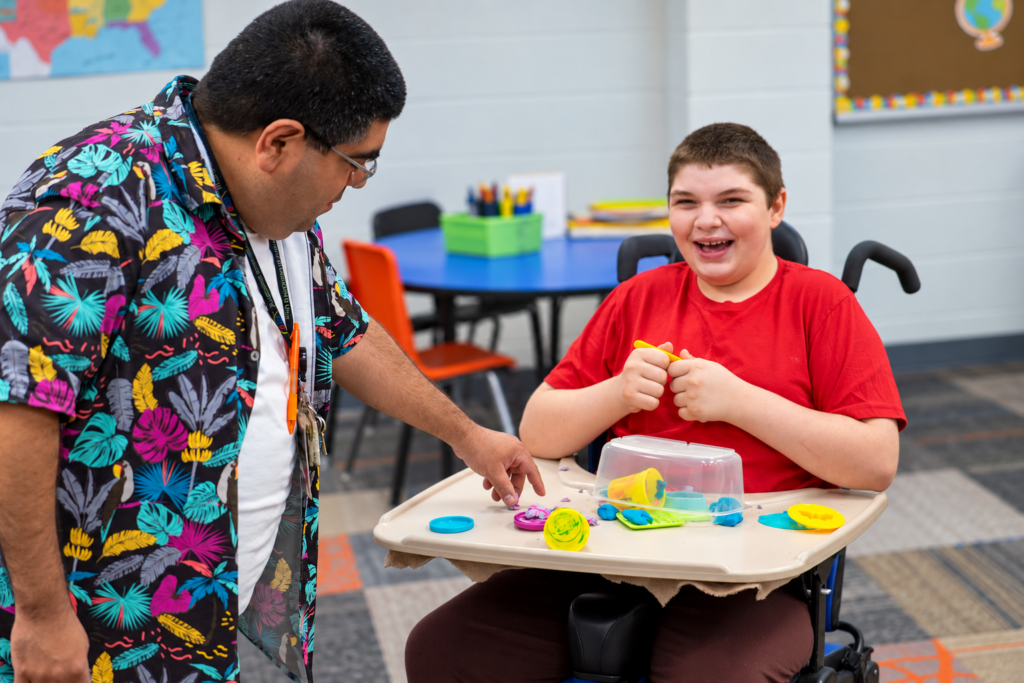 student using play dough in classroom