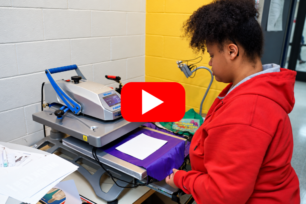 student works on graphic design machine