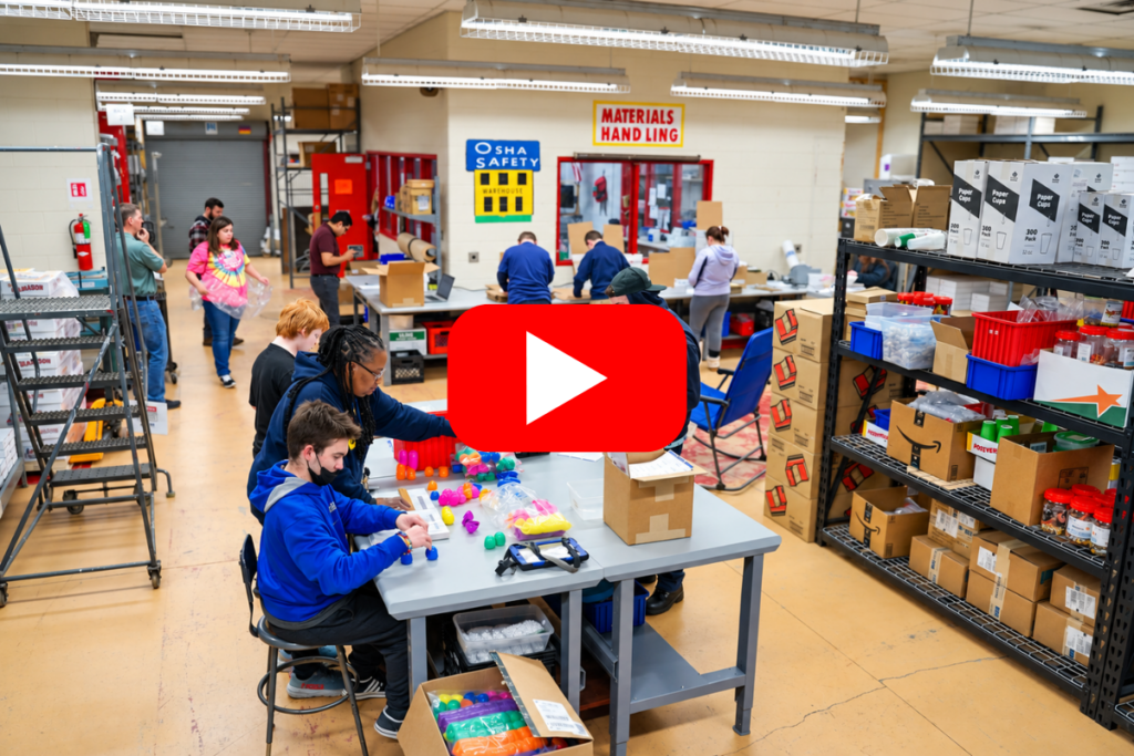 students work with materials in large classroom