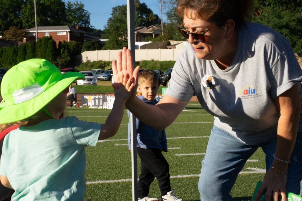 Ms. Robin giving kids a high five