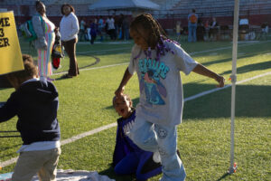 Kids celebrate a touchdown after their activity