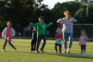 Kids celebrate a touchdown after their activity