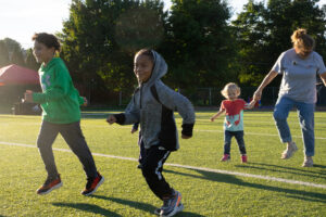 Kids celebrate a touchdown after their activity