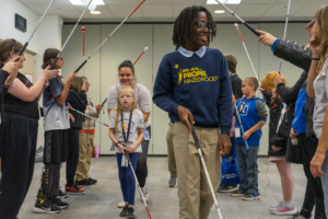 student who is blind or visually impaired participates in cane quest